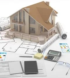 Modellhaus, das auf architektonischen Entwürfen und aufgerollten Plänen steht, umgeben von einem Taschenrechner, Dokumenten, Notizblöcken, Haftnotizen, einem Stift und einer Brille, die für die Planung oder den Bau von Immobilien stehen. 